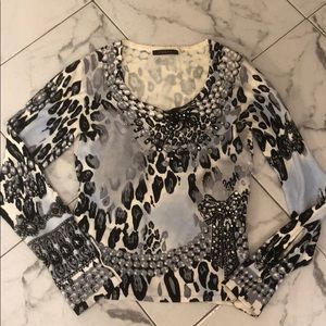 Cyrus sweater with jewels button on sleeve.